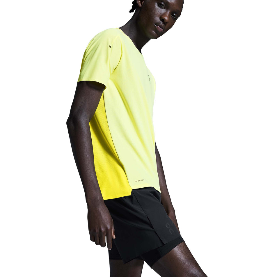 Side view of a model wearing the On Men's 5