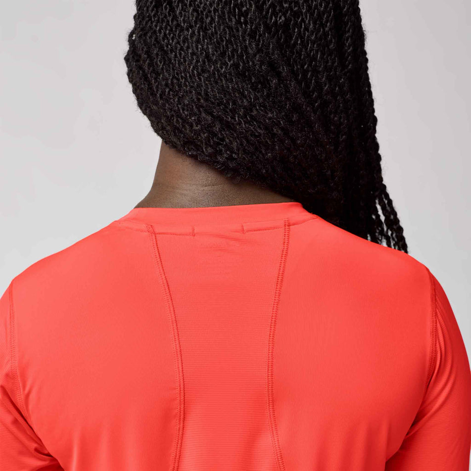 Back view of a model wearing the Brooks Women's Sprint Free Long Sleeve 3.0 in the Neo Cayenne colourway. (8575027282082)