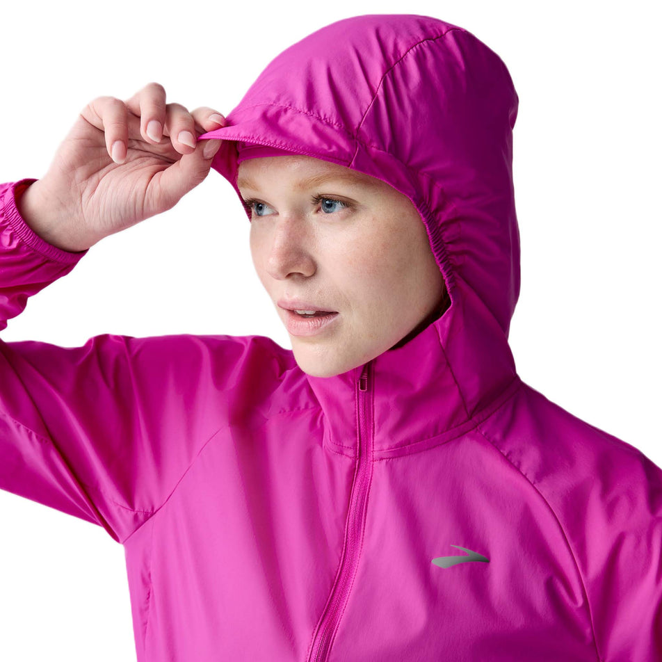 Front view of a model wearing the Brooks Women's Canopy Jacket 2.0 in the Magenta colourway. (8718875951266)