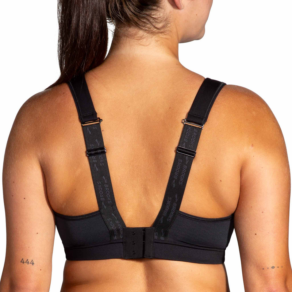 Back view of a model wearing the Brooks Women's Convertible 2.0 Sports Bra - demonstrating the scoopback fit - in the Black colourway. (8636795551906)