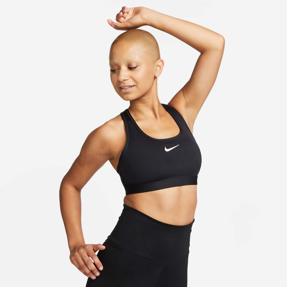Front view of a model wearing a Nike Women's Swoosh Medium Support Padded Sports Bra in the Black/White colourway (8140167086242)