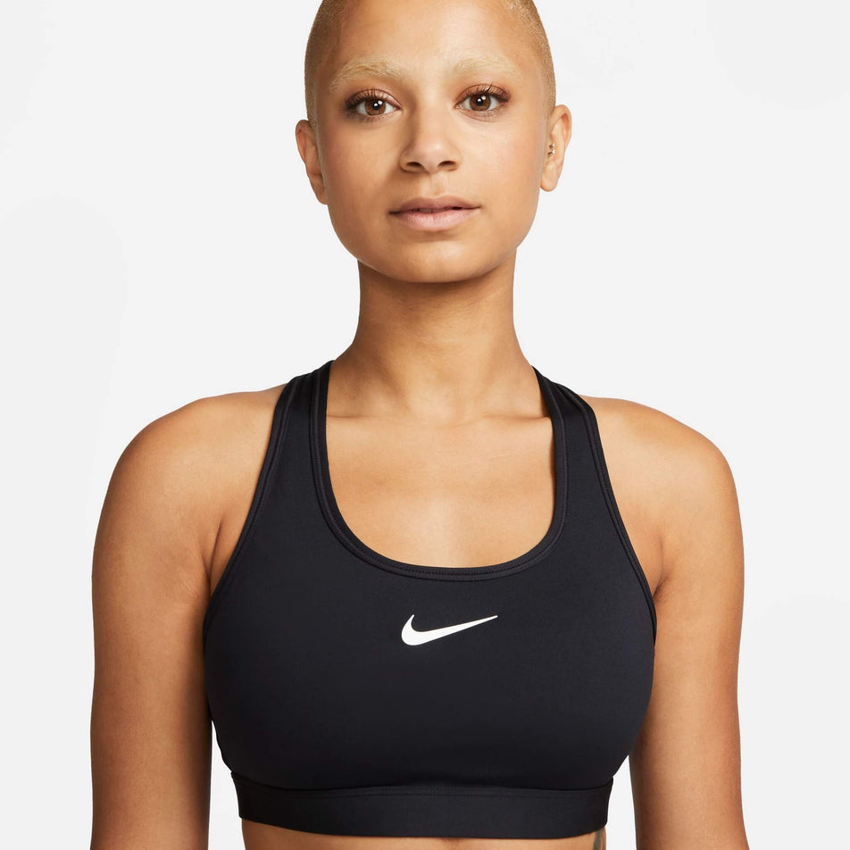 Front view of a model wearing a Nike Women's Swoosh Medium Support Padded Sports Bra in the Black/White colourway (8140167086242)