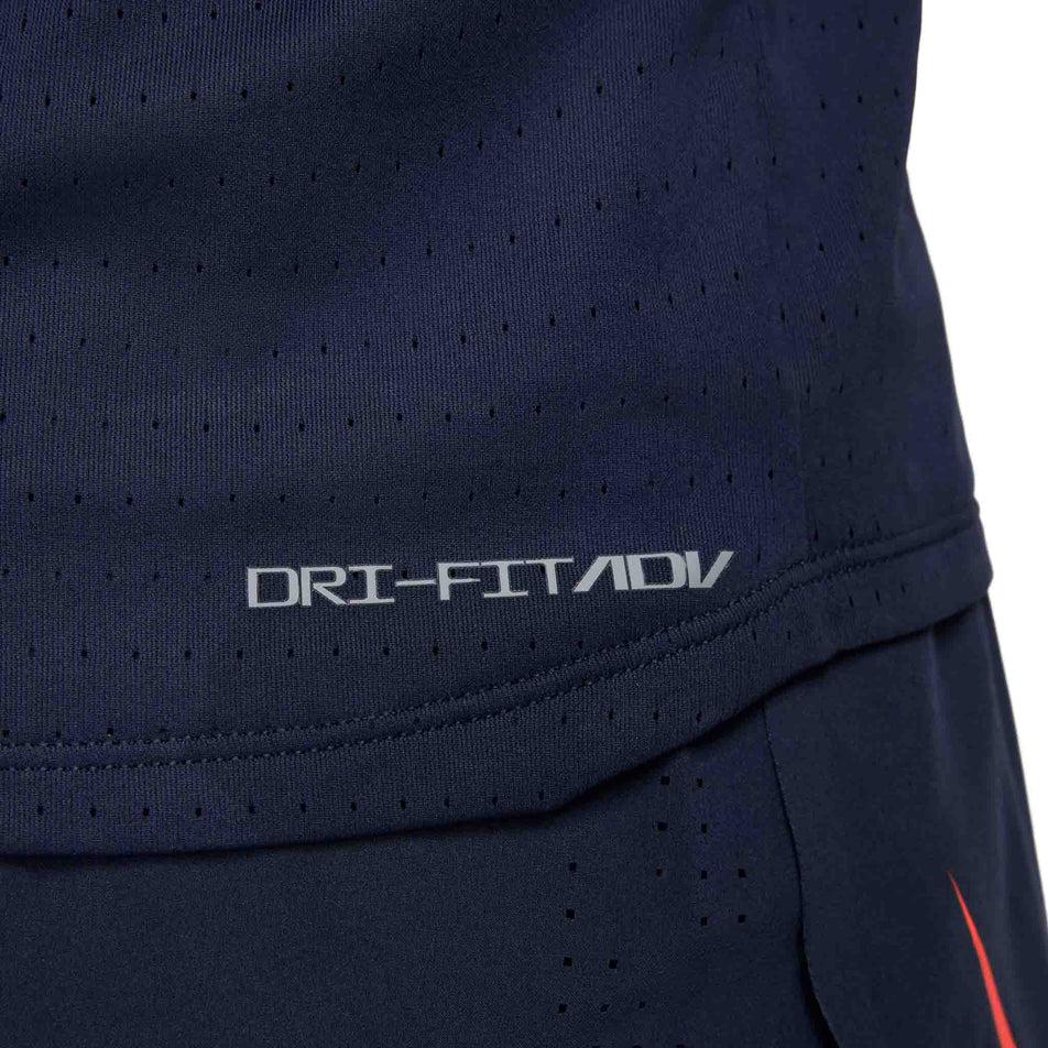 Close up view of the Dri-FIT ADV logo on the Nike Men's AeroSwift Dri-FIT ADV Running Singlet in the Obsidian/Bright Crimson colourway. (8574129176738)