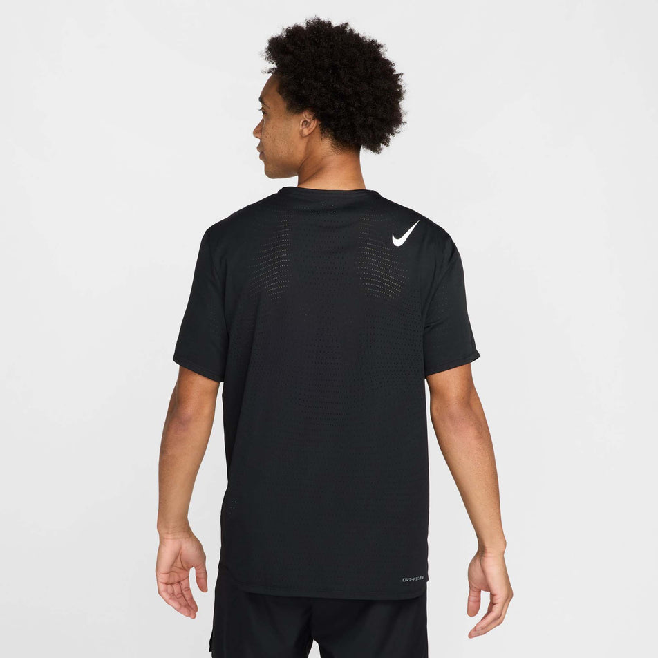 Back view of a model wearing the Nike Men's AeroSwift Dri-FIT ADV Short-Sleeve Running Top in the Black/Summit White colourway.(8560399810722)
