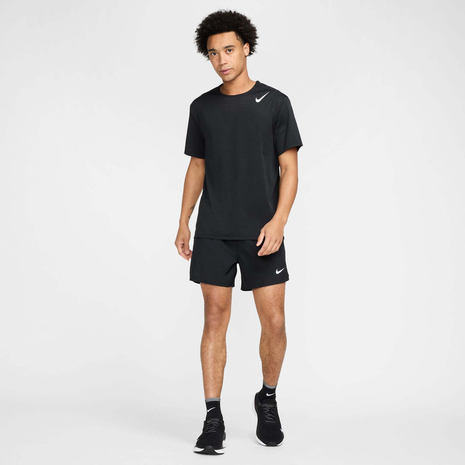 Front view of a model wearing the Nike Men's AeroSwift Dri-FIT ADV Short-Sleeve Running Top in the Black/Summit White colourway.(8560399810722)