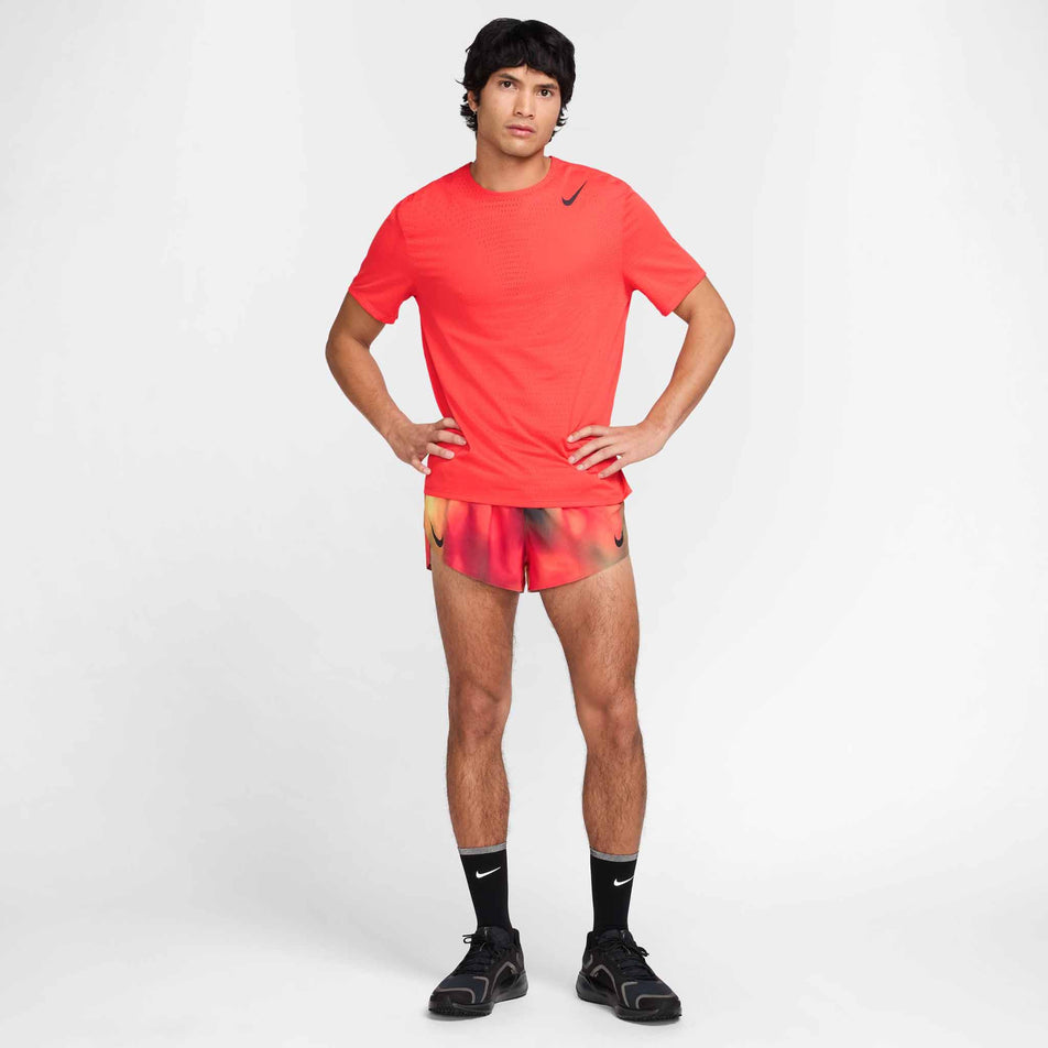 Front view of a model wearing the Nike Men's AeroSwift Dri-FIT ADV Short-Sleeve Running Top in the Light Crimson/Black colourway. (8560409706658)