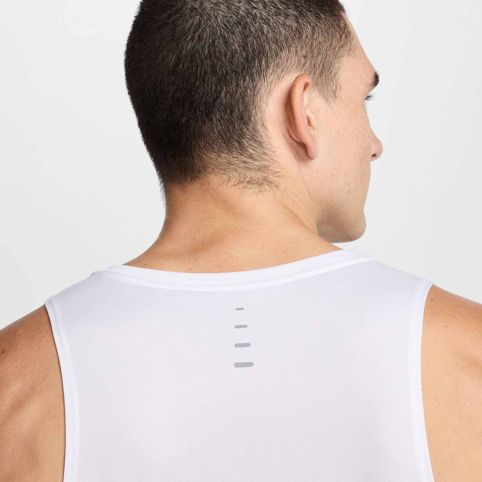 Back view of a model wearing the Nike Men's Stride Dri-FIT ADV Running Tank Top in the White/Reflective Silver colourway. (8620702433442)