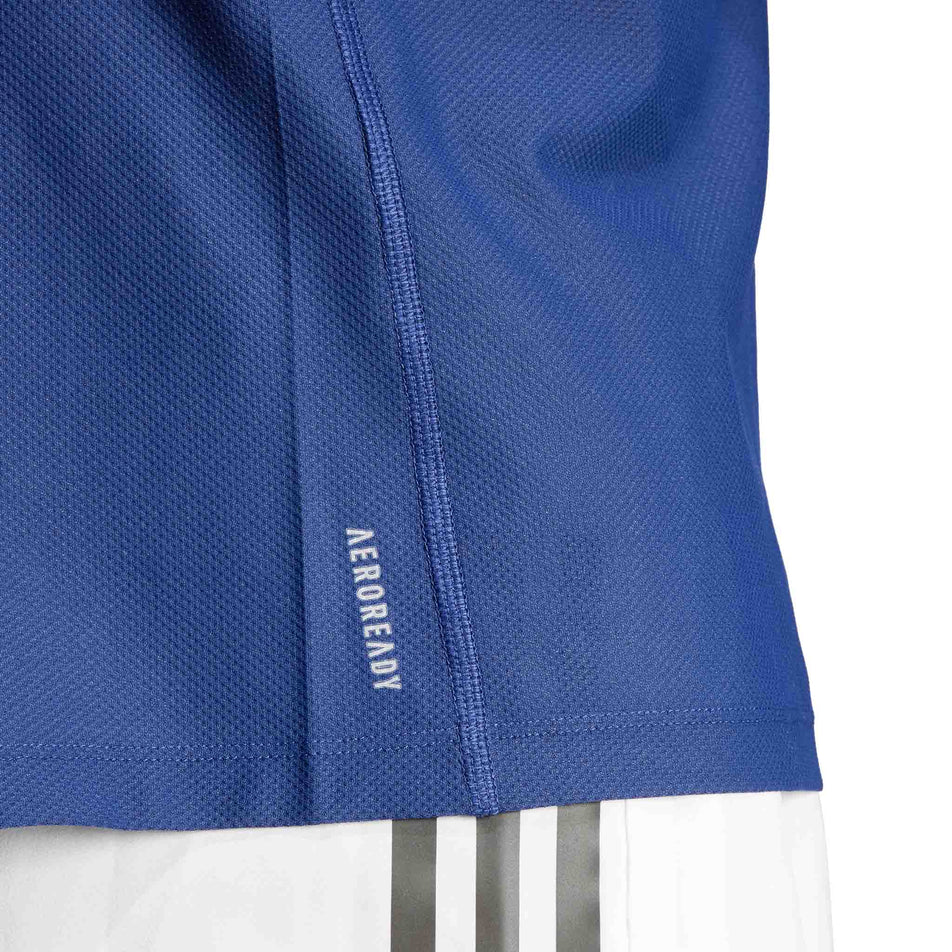 Close-up of the lower left-side of an adidas Men's Own The Run T-Shirt in the Dark Blue colourway. Top is being worn by a model. (8449482588322)