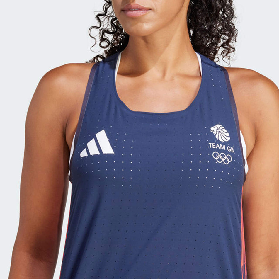 Close-up front view of the upper part of an adidas Women's Team GB Adizero Running Tank Top in the Legend Ink colourway. Top is being worn by a model. (8323995795618)