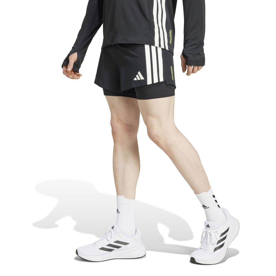 Front view of a model wearing the adidas Men's Adizero 2in1 Short in the Black colourway. (8566982148258)