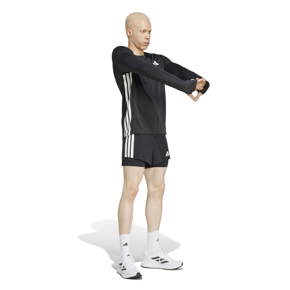 Front view of a model wearing the adidas Men's Adizero 2in1 Short in the Black colourway. (8566982148258)