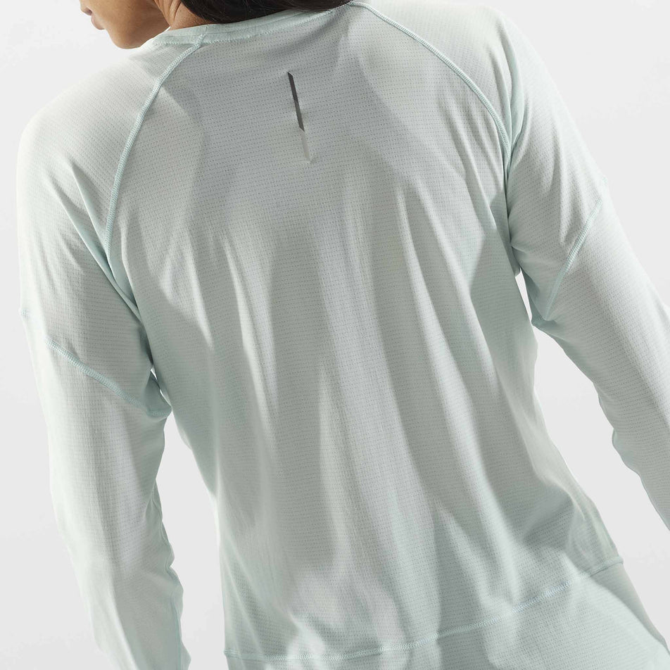 Back view of a model wearing a Salomon Women's Cross Run Long Sleeve T-Shirt in the Misty Blue colourway. (8464163733666)