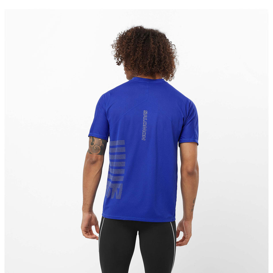 Back view of a model wearing a Salomon Men's Sense Aero Graphic Short Sleeve T-Shirt in the Surf The Web/Rainy Day colourway. Model is also wearing legwear. (8464271802530)