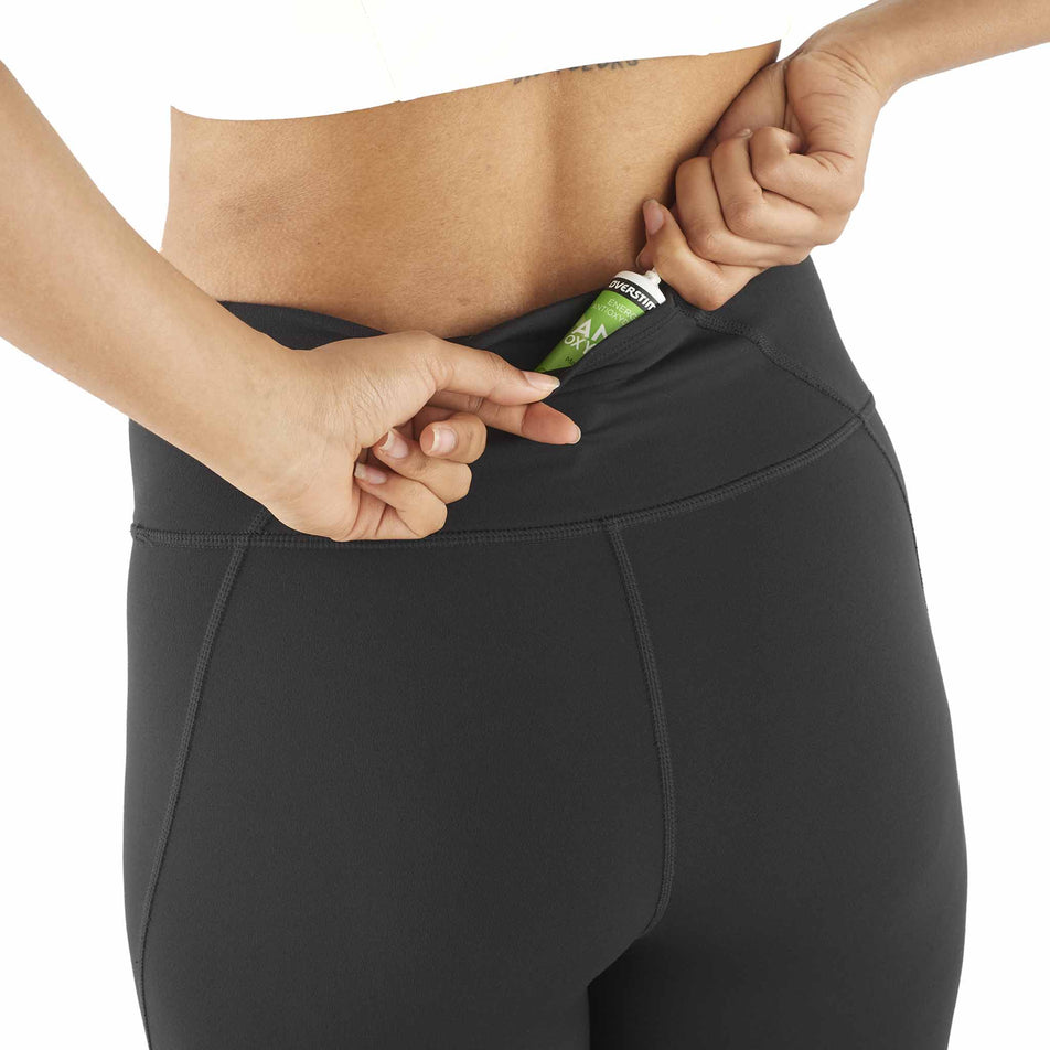 A model demonstrating the storage at the back of the Salomon Women's SHKout Bliss 25