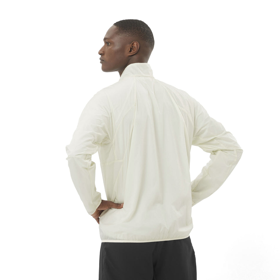Back view of a model wearing the Salomon Men's SHKout Fly Wind Jacket in the Icicle colourway. (8575585222818)