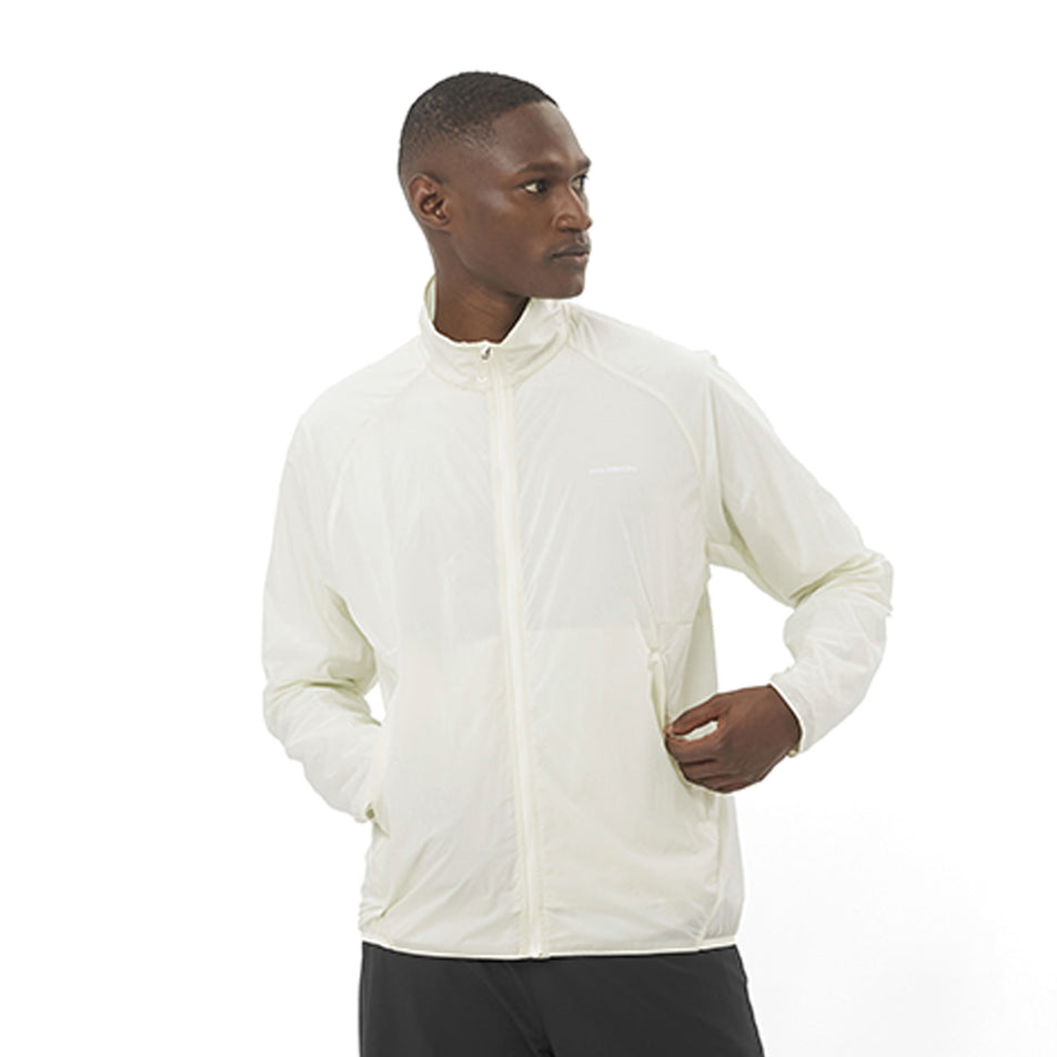 Front view of a model wearing the Salomon Men's SHKout Fly Wind Jacket in the Icicle colourway. (8575585222818)