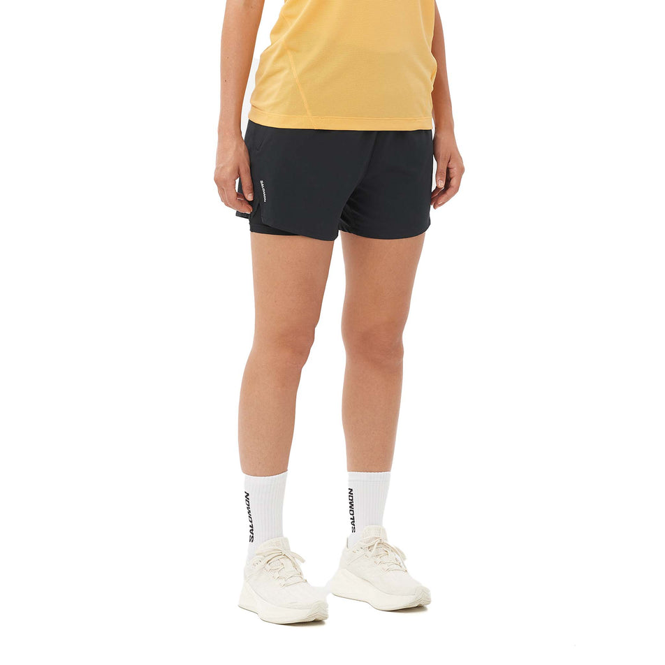 Front view of a model wearing the Salomon Women's SHKout Core 2in1 4