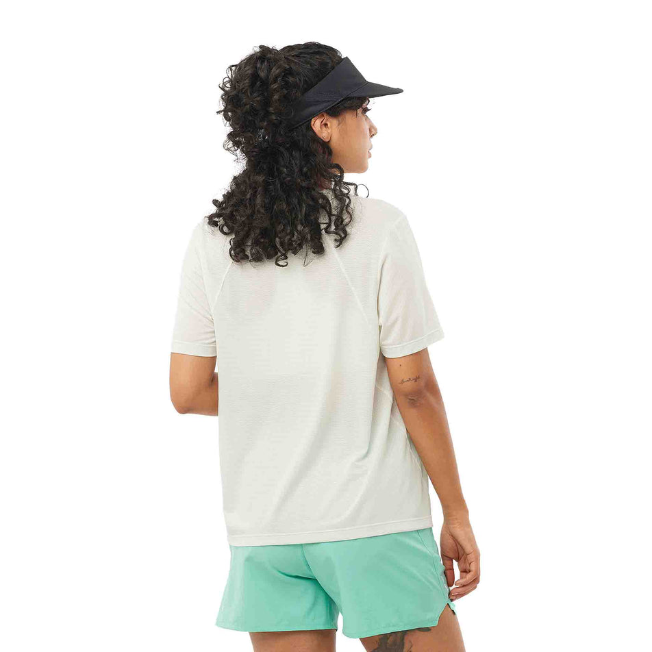 Back view of a model wearing the Salomon Women's SHKout Core Short Sleeve T-Shirt in the Icicle colourway. (8575550980258)