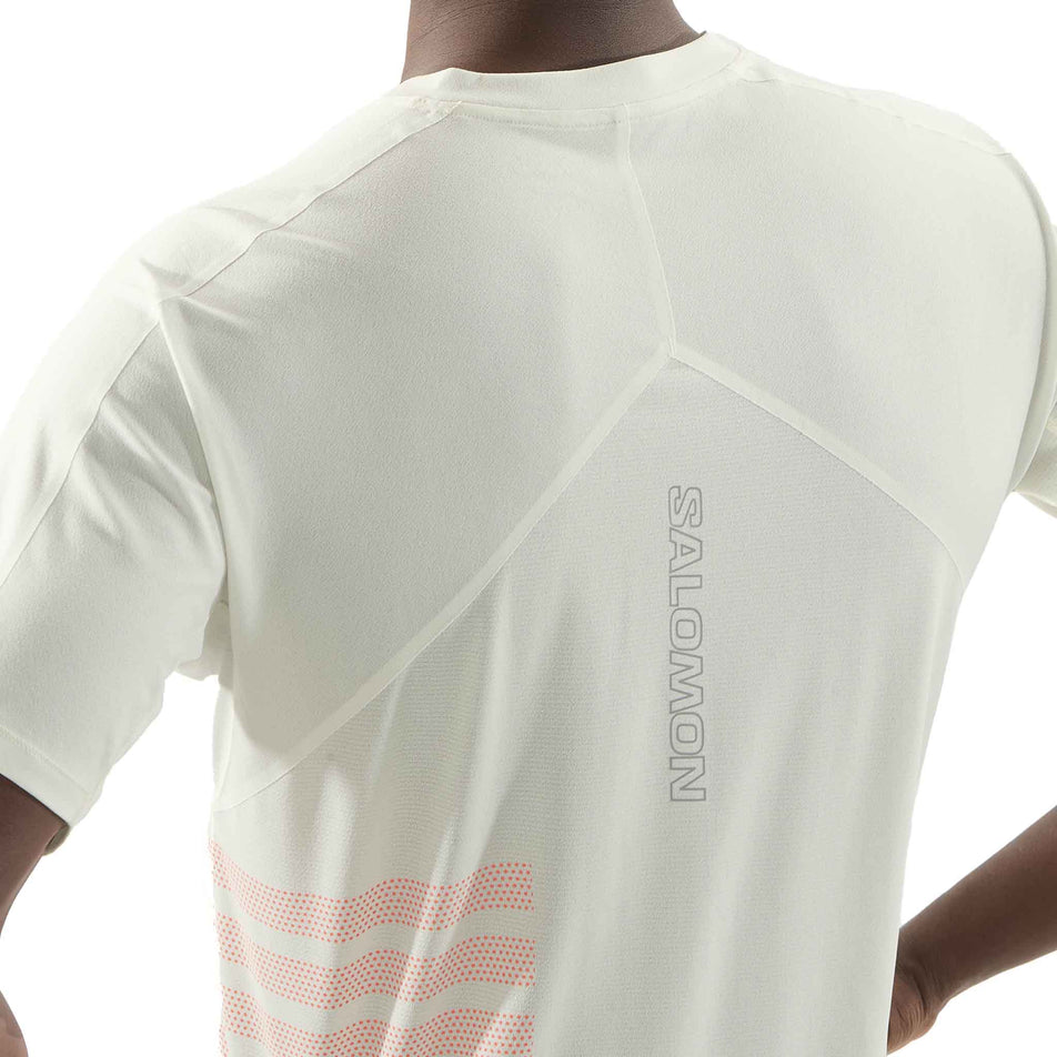 Back view of a model wearing the Salomon Men's Sense Aero Graphic Short Sleeve T-Shirt in the Icicle/Neon Flame colourway. (8575560482978)