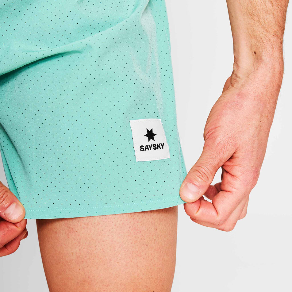 Close-up view of the SAYSKY logo on a pair of SAYSKY Men's Pace Air Shorts 5