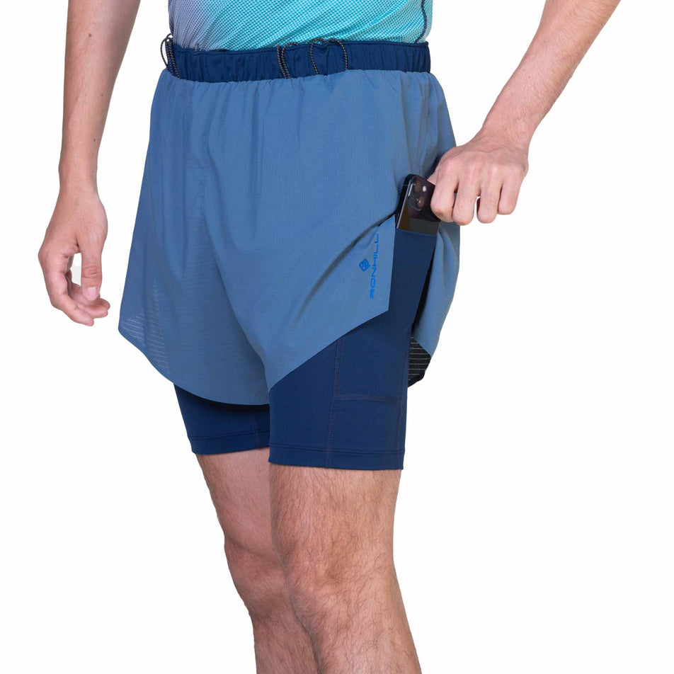 Front view of a model wearing the Ronhill Men's Tech Race Twin Short in Lake/Dark Navy colourway. (8565238464674)