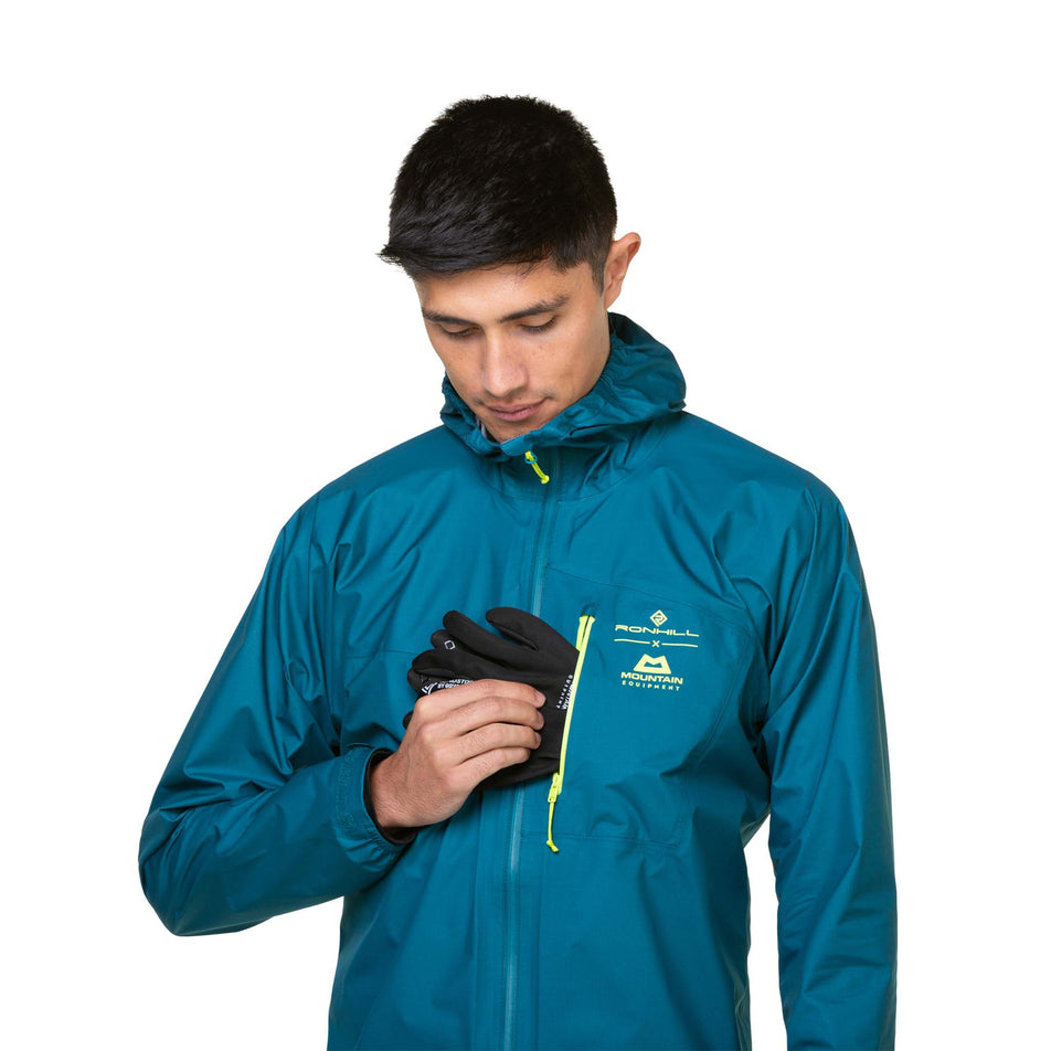 A model demonstrating that gloves can be stored in the chest pocket of a Ronhill Men's Tech GORE-TEX Mercurial Jacket. The jacket is being worn by the model. (8470598418594)