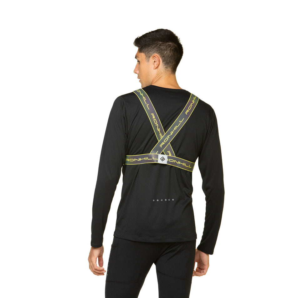 Back view of a model wearing the Ronhill Unisex Reflect Belt in the Fluo Yellow/Reflect colourway. Model is also wearing leggings and a top. (8491318313122)