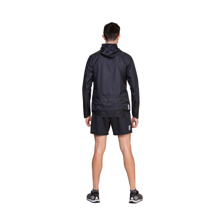 Back view of a model wearing the Ronhill Men's Tech All-Terrain Jacket in the All Black colourway. (8563617431714)
